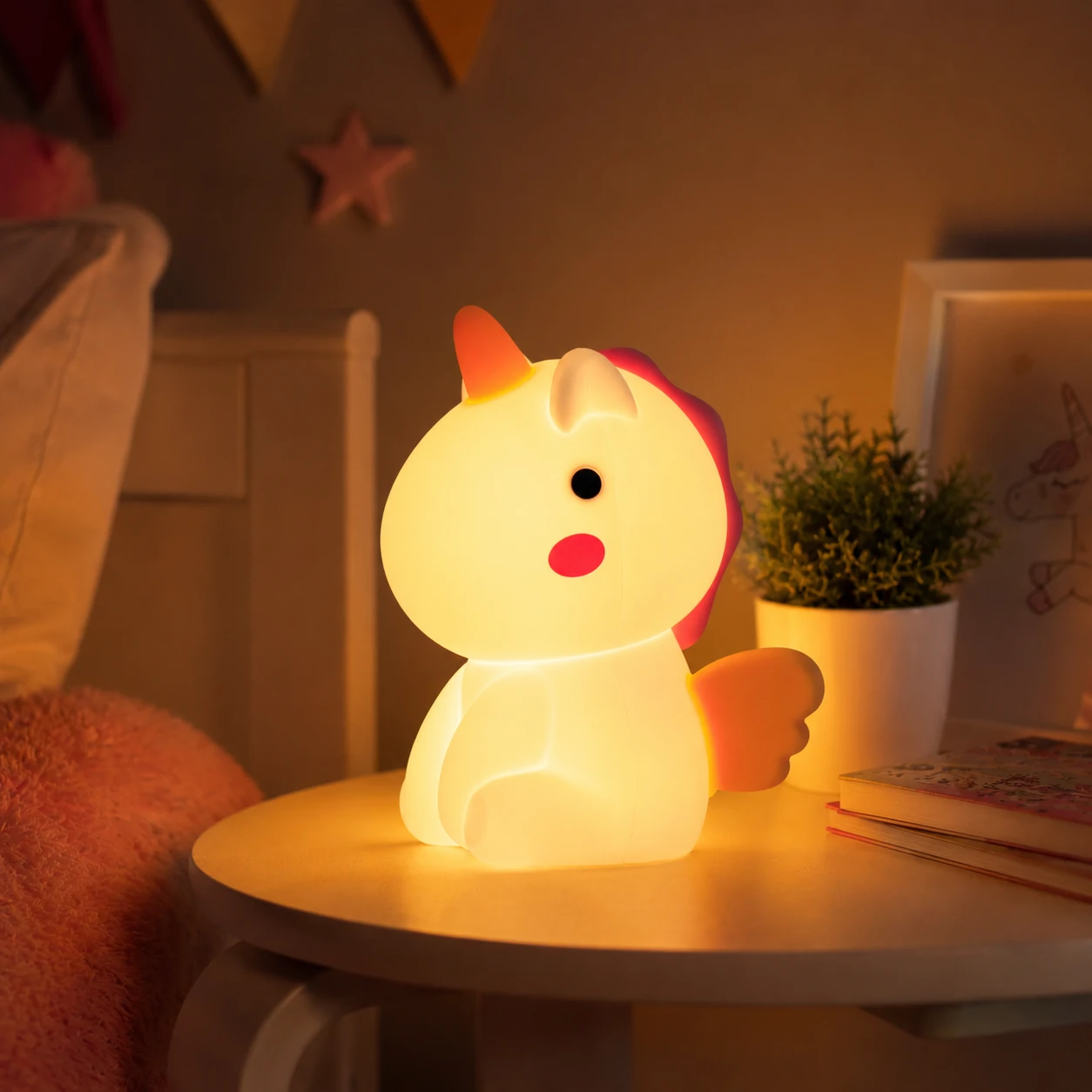 Soft unicorn silicone night light glowing on a bedside table