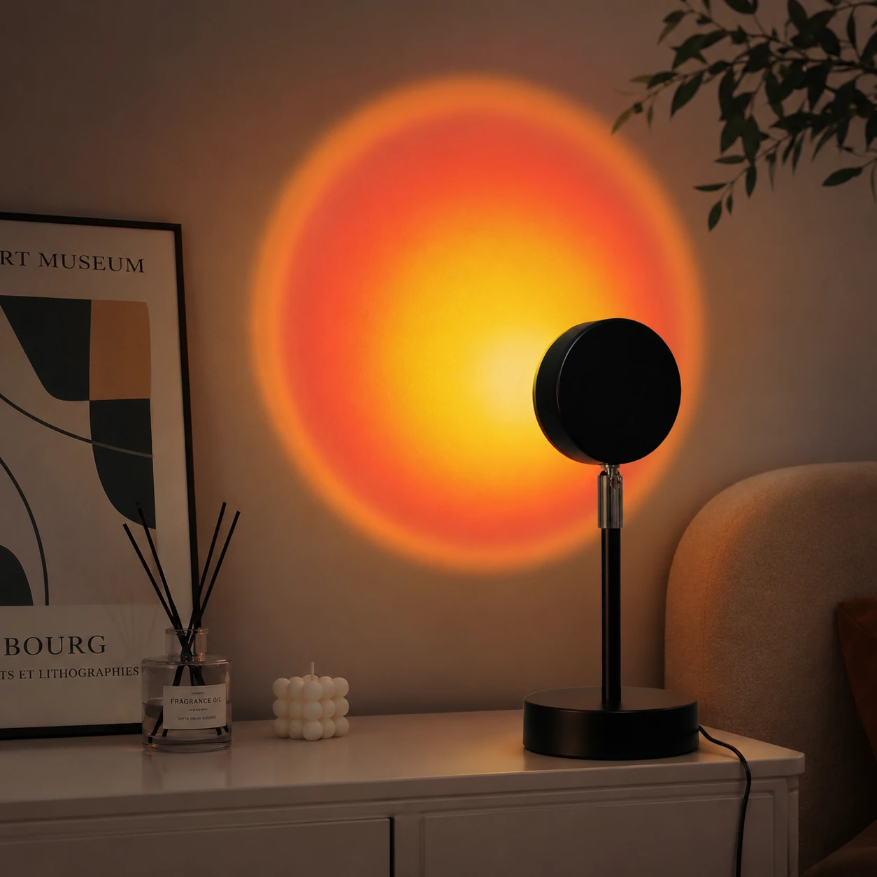 Sunset projection lamp casting an orange glow on a wall
